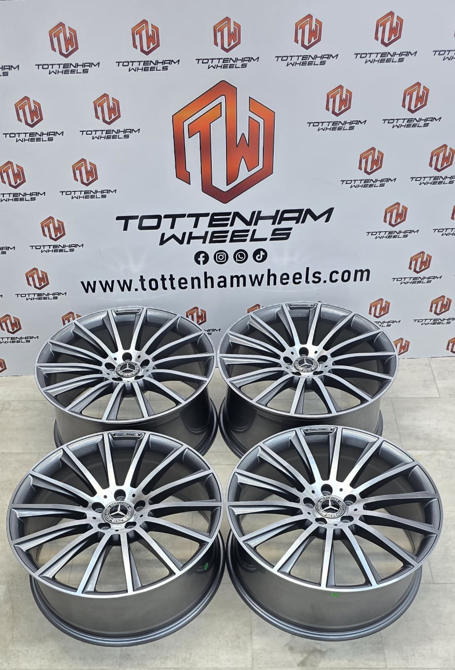 A set of four diamond-cut Mercedes AMG alloys finished at Tottenham Wheels, photographed against the workshop backdrop